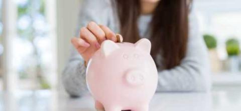 Saving money in piggy bank