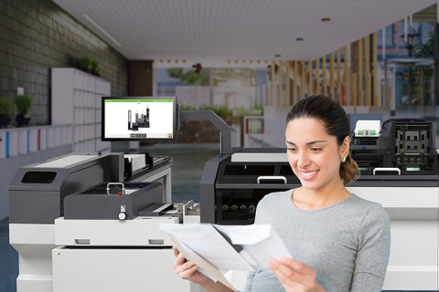 woman reading letter in front of ds1200 folder inserter