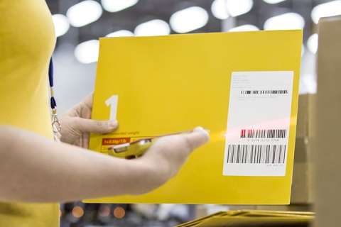 Piece of mail being scanned with a barcode