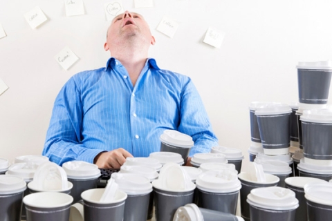 man with many coffee cups