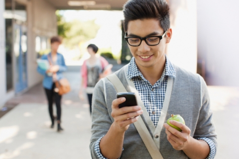 Student eating apple on campus