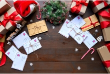 Christmas letters scattered on the floor around presents and decorations