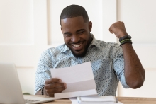 Enthusiastic man reading a paper report